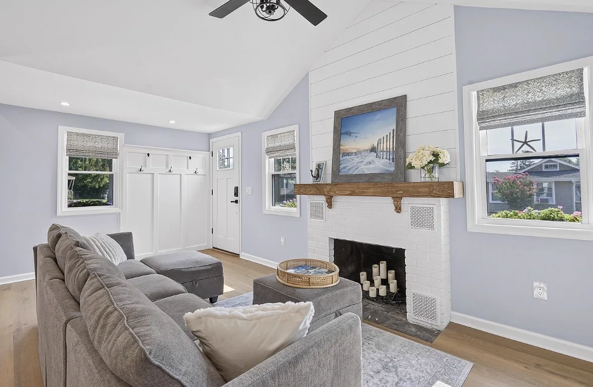 Living room with a shiplap fireplace and reclaimed wood mantel at The Salted Cottage, Spring Lake NJ