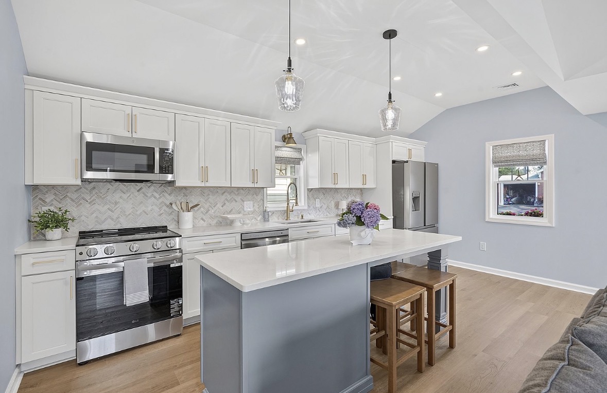 Kitchen with quartz island and herringbone backsplash